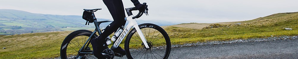 Giant propel climbing a hill with a saddle bag